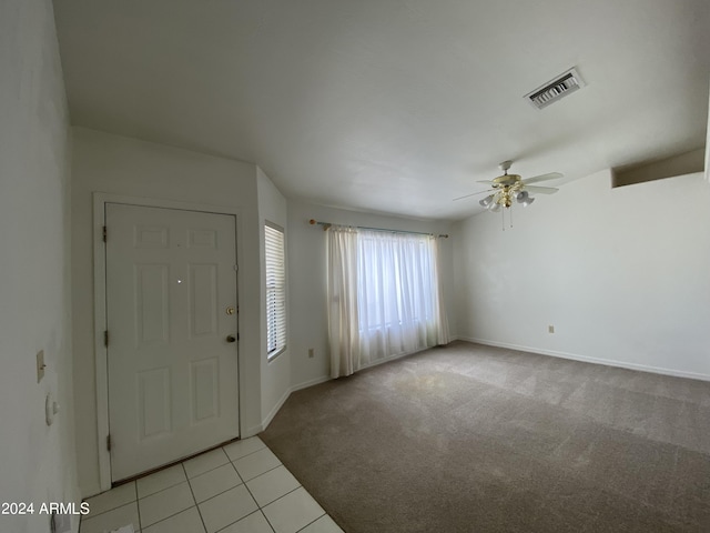 carpeted foyer featuring ceiling fan