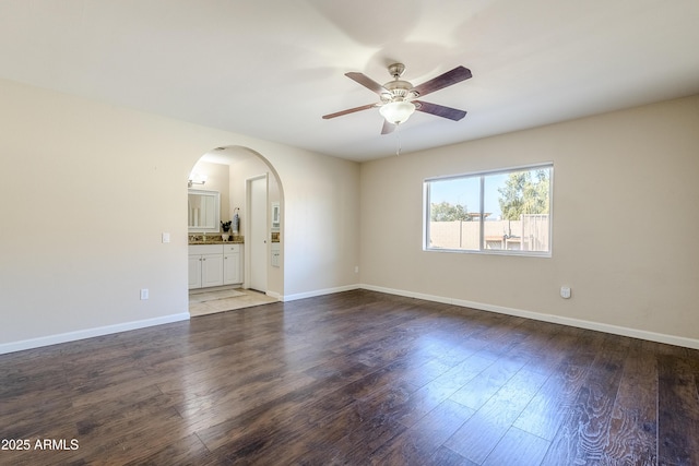 unfurnished room featuring dark wood-type flooring and ceiling fan