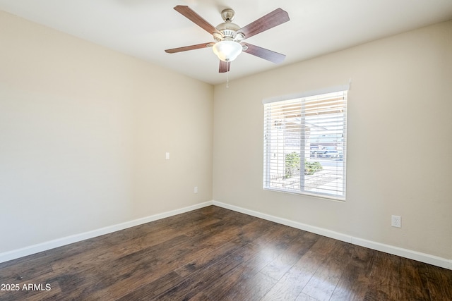 spare room with dark hardwood / wood-style floors and ceiling fan