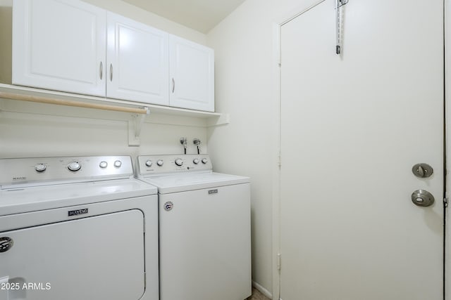 laundry room with cabinets and washing machine and clothes dryer