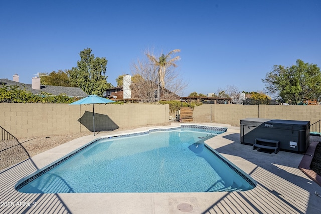 view of pool with a hot tub