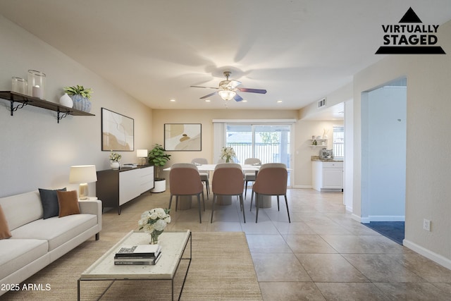 living room featuring ceiling fan and light tile patterned floors