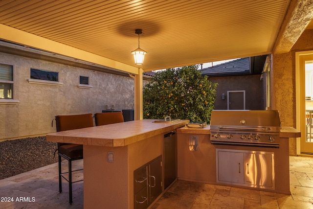 view of patio featuring area for grilling and exterior bar