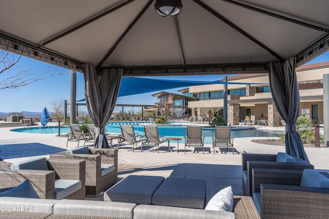 view of patio featuring a gazebo and a community pool