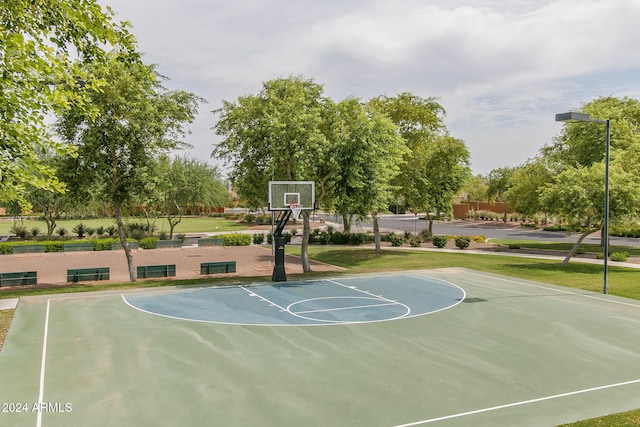 view of basketball court with a lawn