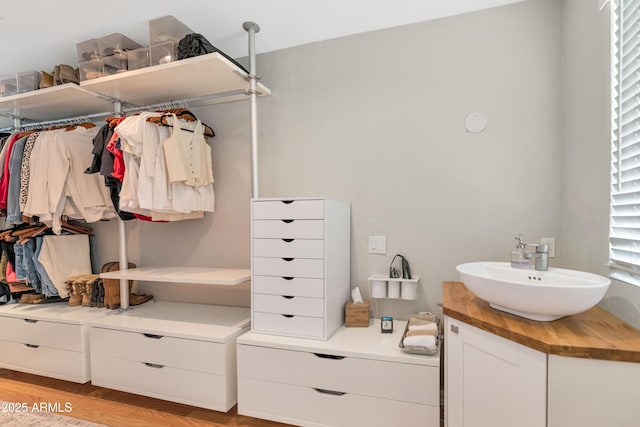 5971 E Orange Blossom Ln, Phoenix, AZ 85018 - walk in closet with a sink and light wood finished floors