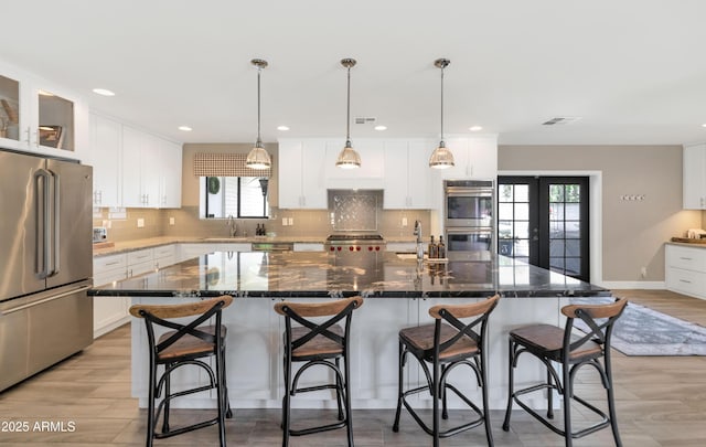 5971 E Orange Blossom Ln, Phoenix, AZ 85018 - kitchen featuring stainless steel appliances, tasteful backsplash, white cabinets, and recessed lighting