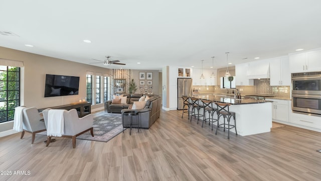 5971 E Orange Blossom Ln, Phoenix, AZ 85018 - living room featuring light wood-type flooring, recessed lighting, and ceiling fan