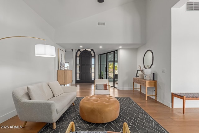 living room featuring hardwood / wood-style floors and high vaulted ceiling