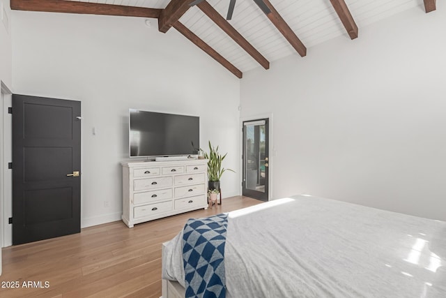 bedroom with beam ceiling, high vaulted ceiling, access to outside, and light wood-type flooring