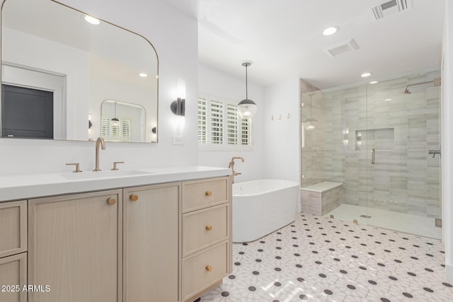 bathroom featuring vanity and independent shower and bath