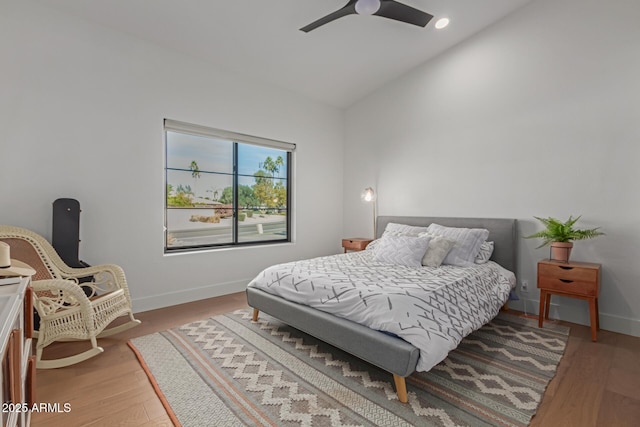 bedroom with hardwood / wood-style flooring, ceiling fan, and lofted ceiling