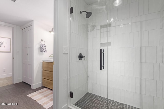 bathroom featuring vanity and an enclosed shower