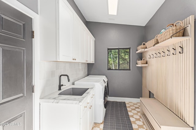 laundry room featuring separate washer and dryer, sink, and cabinets