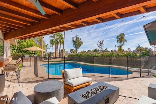 view of pool featuring a patio and an outdoor fire pit