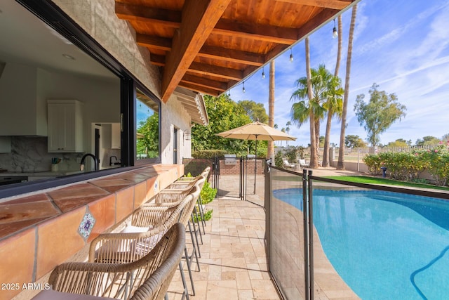 view of pool featuring an outdoor wet bar