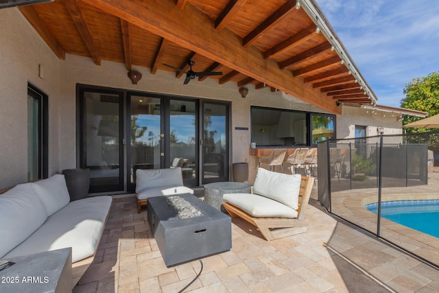 view of patio / terrace featuring an outdoor living space with a fire pit and ceiling fan