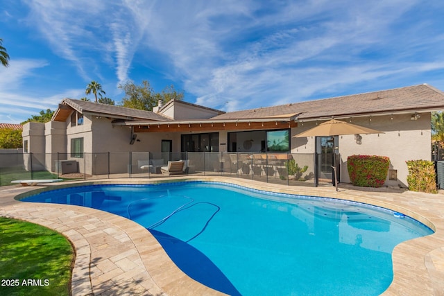 view of pool with a diving board and a patio