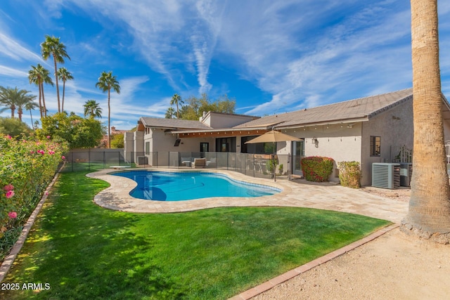 view of swimming pool featuring central AC unit, a lawn, and a patio area