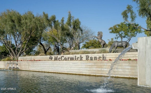 community sign with a water view