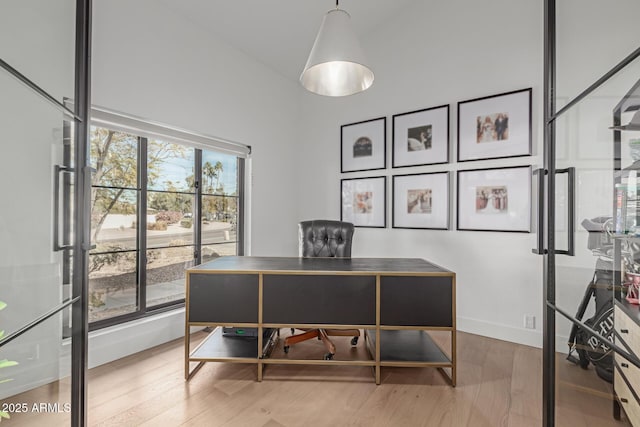 office area featuring vaulted ceiling and hardwood / wood-style floors