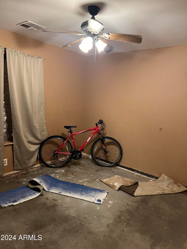 misc room featuring ceiling fan and concrete floors