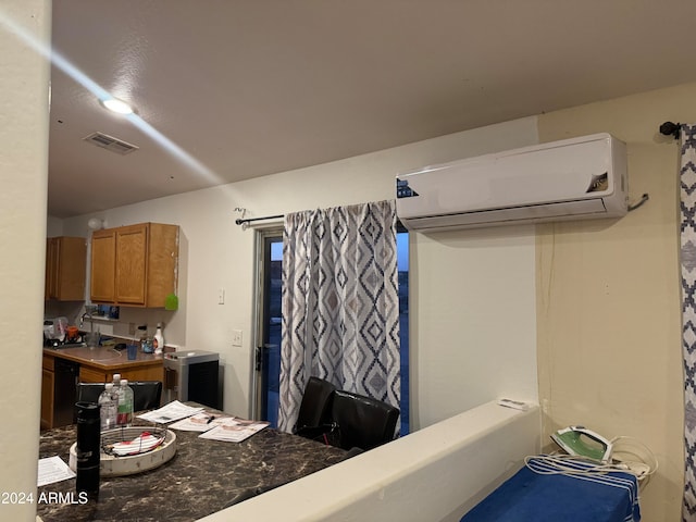 interior space with an AC wall unit and black dishwasher