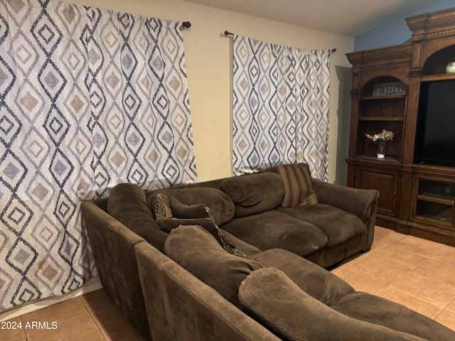 tiled living room featuring lofted ceiling