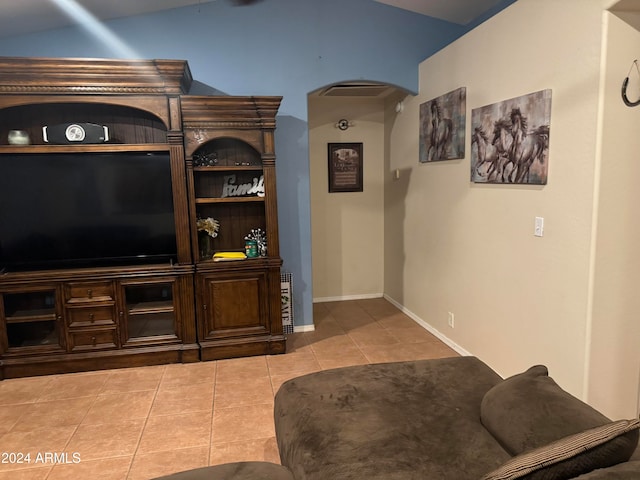 living room featuring light tile patterned floors and vaulted ceiling