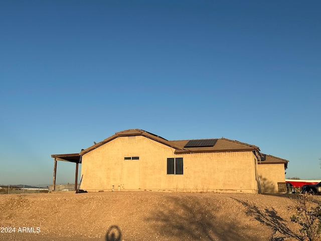 view of home's exterior with solar panels