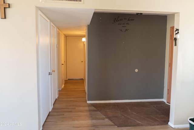 corridor with wood-type flooring