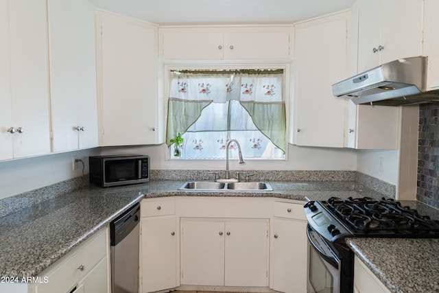 kitchen featuring sink, appliances with stainless steel finishes, decorative backsplash, and white cabinetry