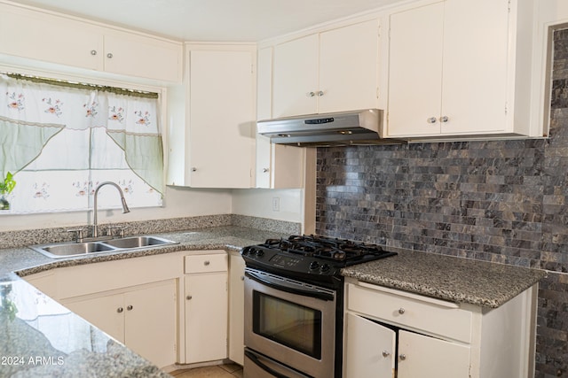 kitchen with tasteful backsplash, sink, stainless steel range with gas cooktop, white cabinets, and range hood