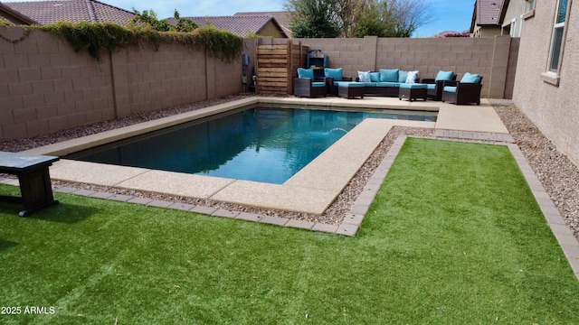 view of swimming pool featuring an outdoor living space and a lawn