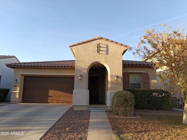 mediterranean / spanish-style house with a garage