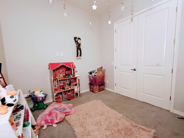 recreation room with light colored carpet