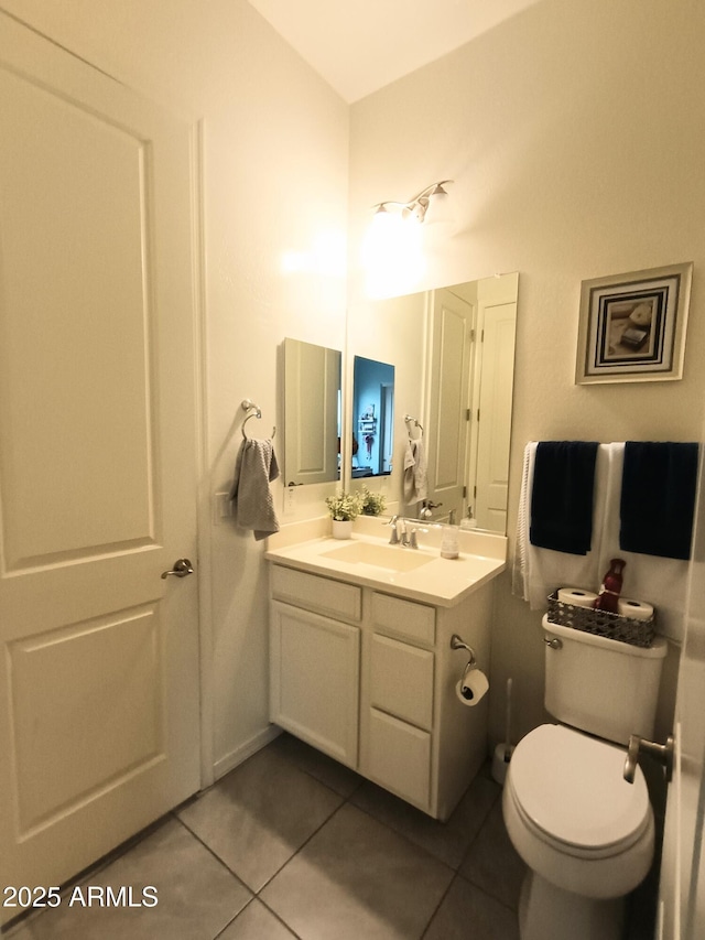 bathroom featuring tile patterned floors, vanity, and toilet