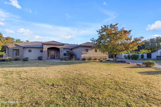 mediterranean / spanish-style home featuring a front lawn