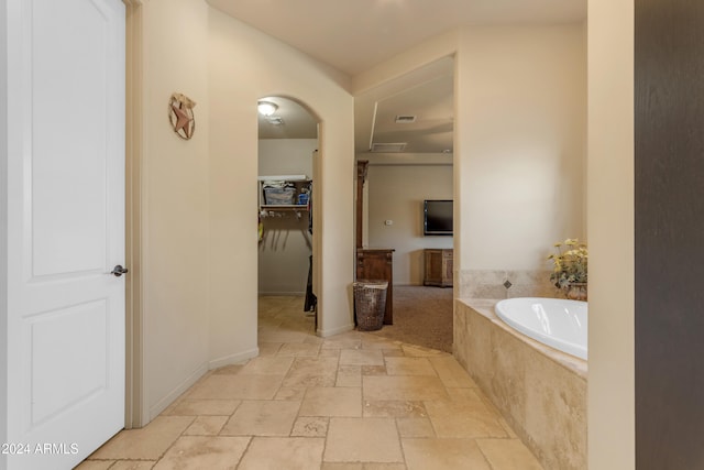 bathroom featuring tiled tub