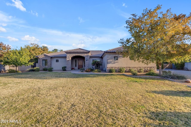 mediterranean / spanish home featuring a front yard