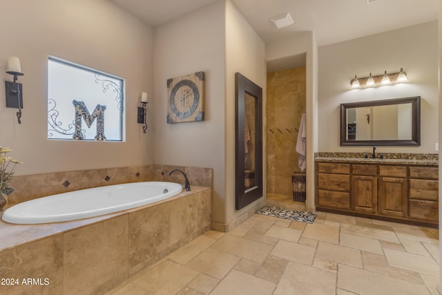 bathroom featuring vanity and shower with separate bathtub