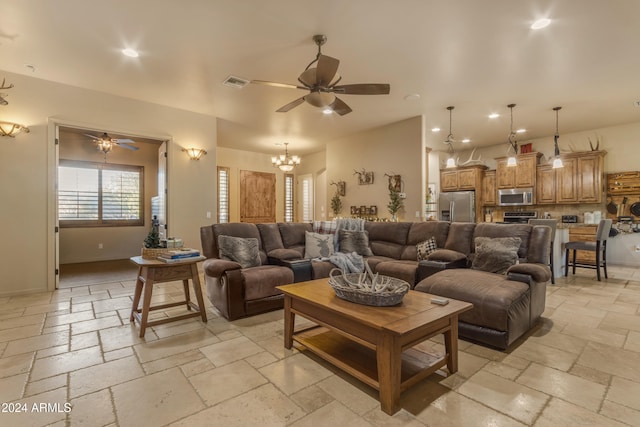 living room with ceiling fan with notable chandelier