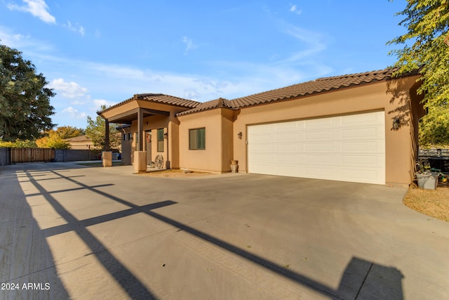 mediterranean / spanish house with a garage