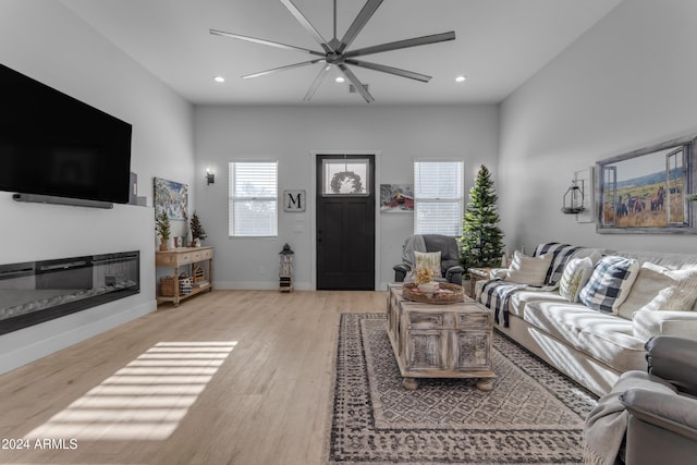 living room with ceiling fan, a healthy amount of sunlight, and light hardwood / wood-style floors