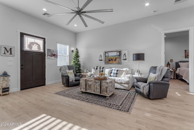 living room with ceiling fan and light hardwood / wood-style flooring