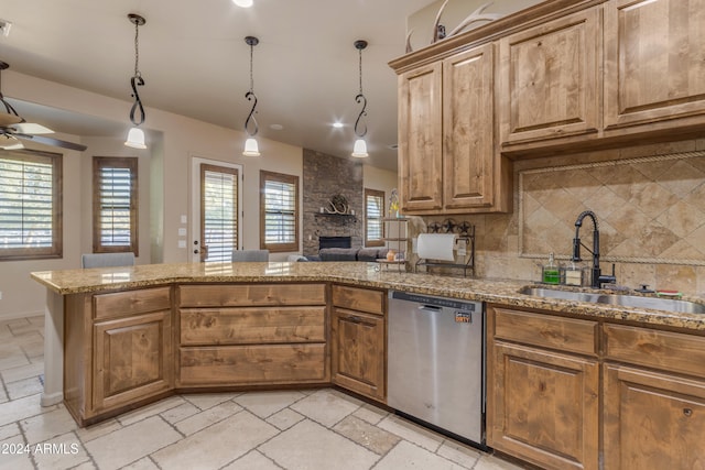 kitchen featuring decorative light fixtures, decorative backsplash, sink, ceiling fan, and stainless steel dishwasher