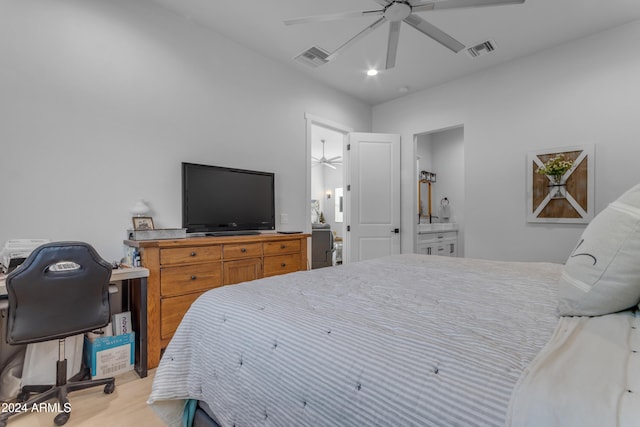 bedroom featuring light hardwood / wood-style floors, ensuite bathroom, and ceiling fan