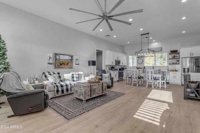 living room featuring ceiling fan and light hardwood / wood-style flooring