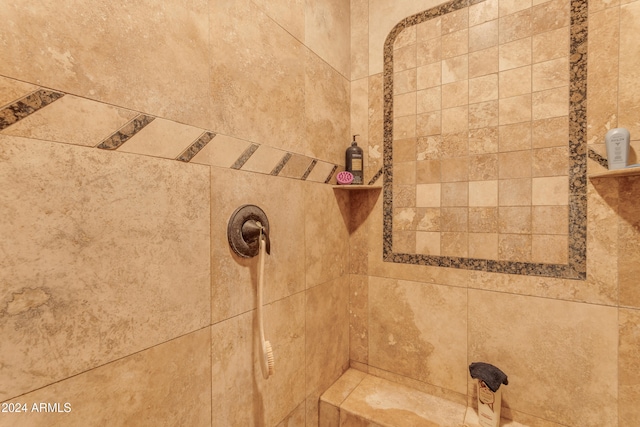 interior details with a tile shower