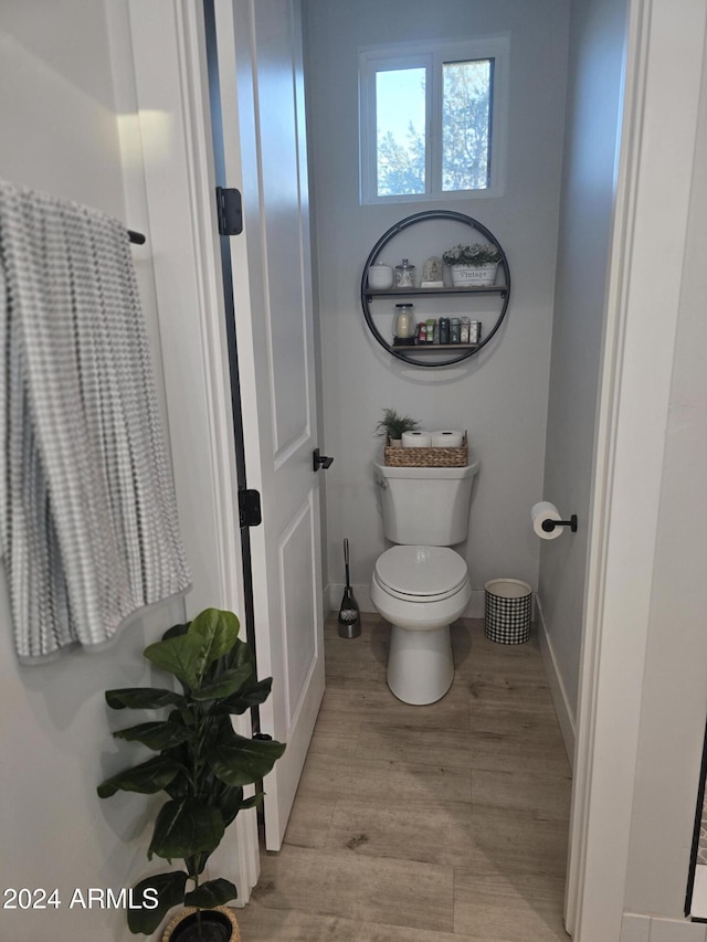 bathroom featuring toilet and hardwood / wood-style flooring